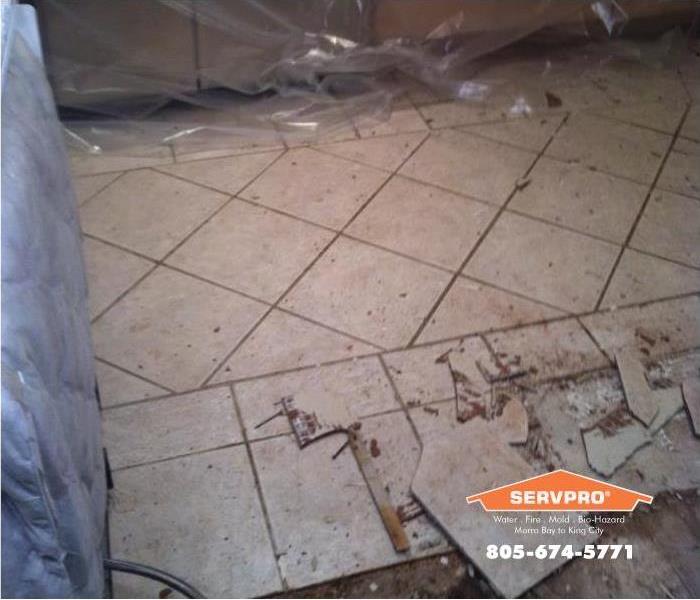 a picture of a tile floor being removed because of water damage