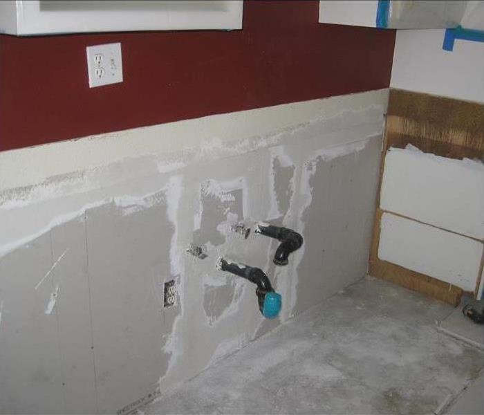 a picture of a bathroom after the drywall has been put back